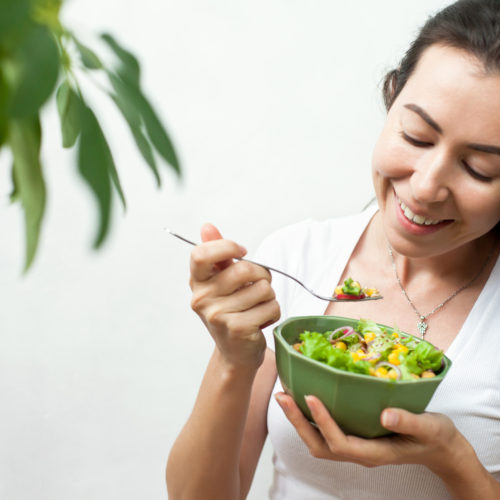 a-young-woman-eating-a-salad-eating-healthy-wellnest