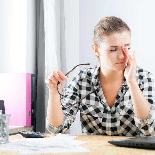 tired-woman-with-eye-pain-during-working-in-home-wellnest