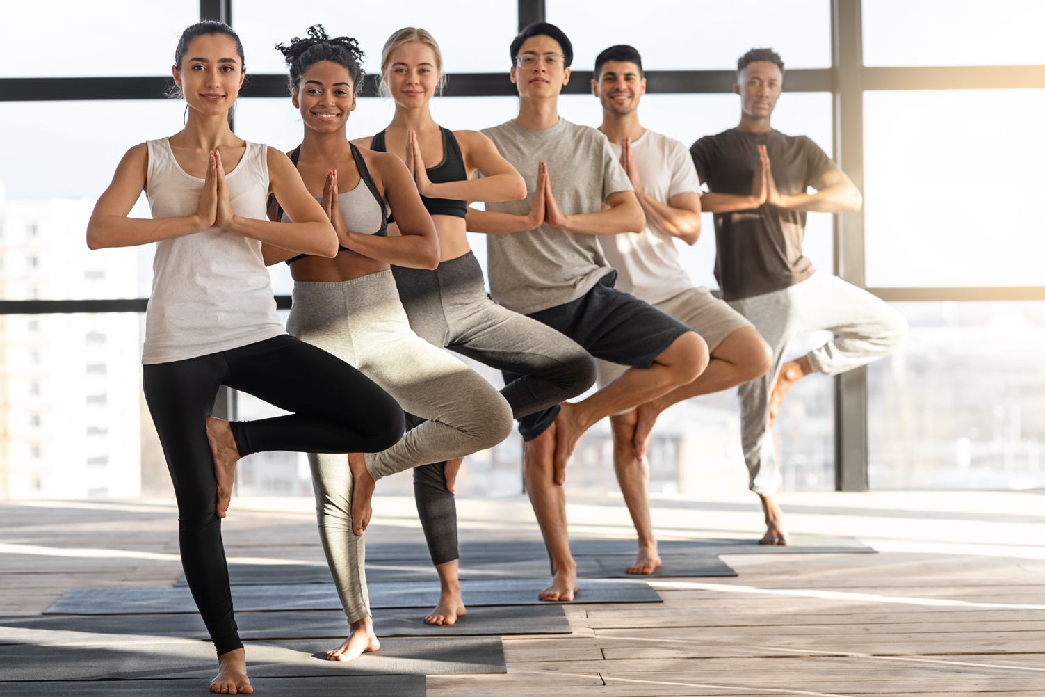 vrksasana-yoga-group-of-happy-multiethnic-people