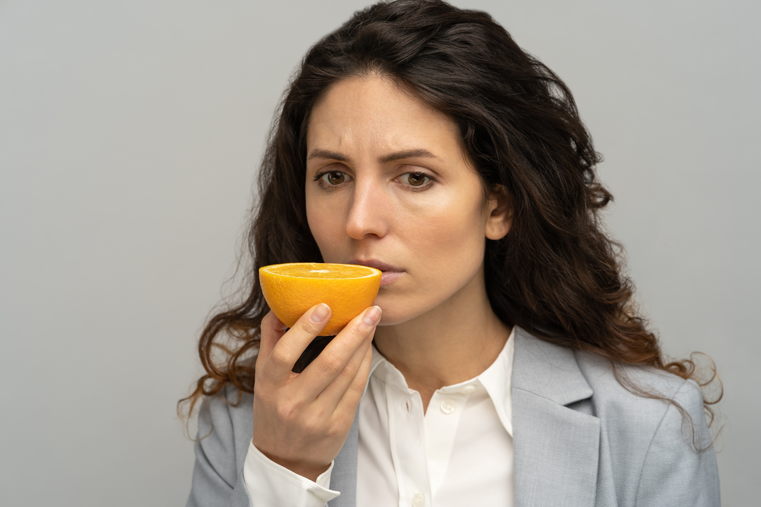 sick-business-woman-trying-to-sense-smell-of-half-corona-symptoms-wellnest