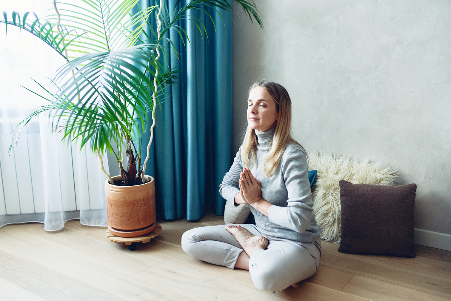 young-healthy-beautiful-woman-in-gray-cloths-practicing-yoga-wellnest